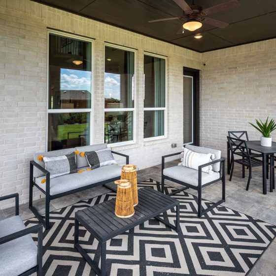 Outdoor Patio with fun, black, modern patio furniture designed by Highland Homes at VIDA San Antonio