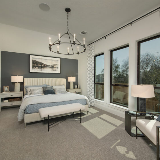 A Large carpeted master bedroom decorated and designed by Perry Homes