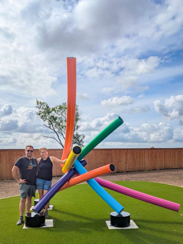 Wanderlust Ironwork artists stand next to their new sculpture at VIDA San Antonio