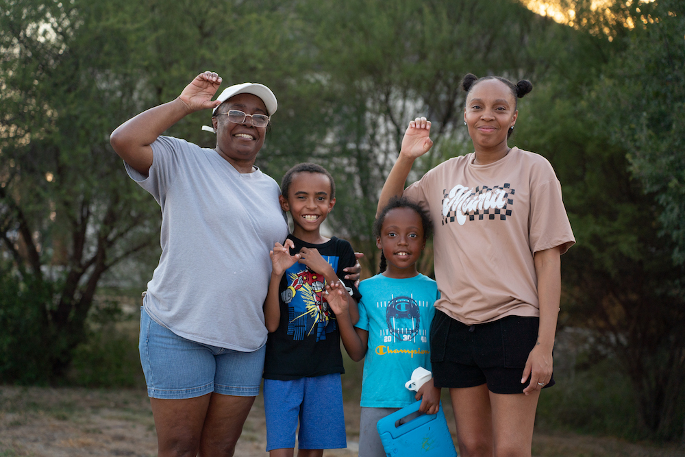 A family holds up Jaguar Paws