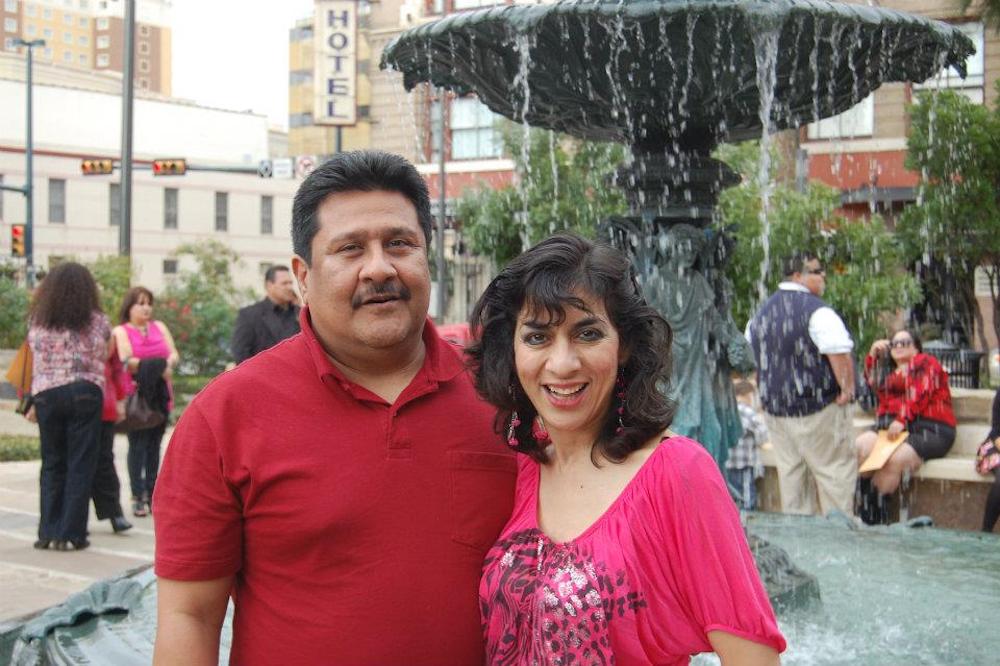 Oswaldo and Norma Astorga-Garcia stand in front of a fountain