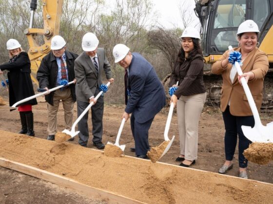 Texas A&M University staff shovel the first scoops of dirt at the University Health VIDA Clinic Groundbreaking