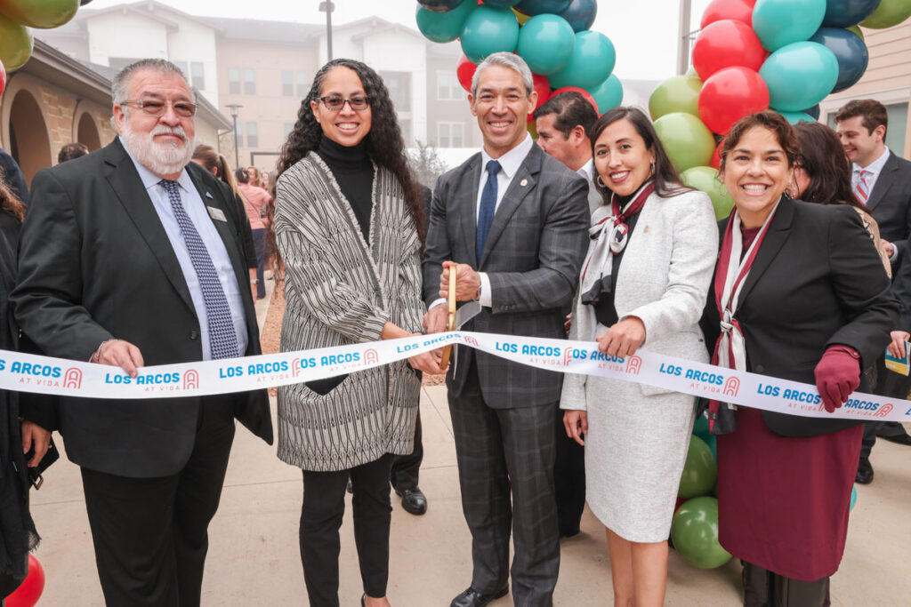 San Antonio leaders, among them Mayor Nirenberg, prepare to cut the ribbon at the Los Arcos Apartments grand opening at VIDA San Antonio.