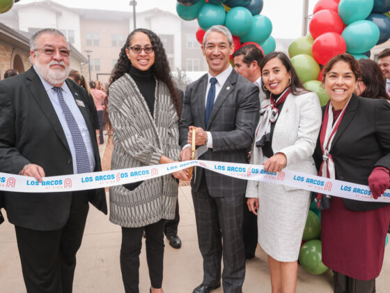 San Antonio leaders, among them Mayor Nirenberg, prepare to cut the ribbon at the Los Arcos Apartments grand opening at VIDA San Antonio.