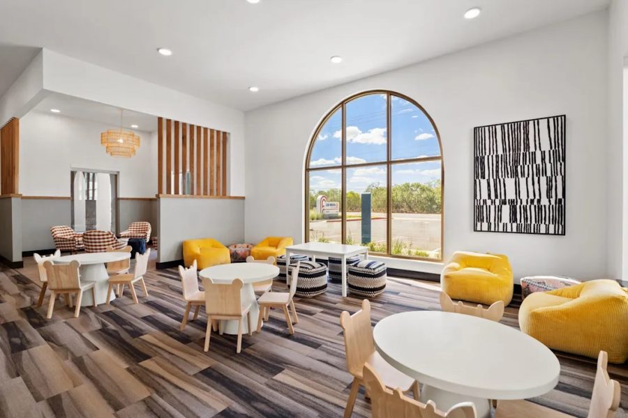 A vibrant apartment lobby spotted with yellow chairs