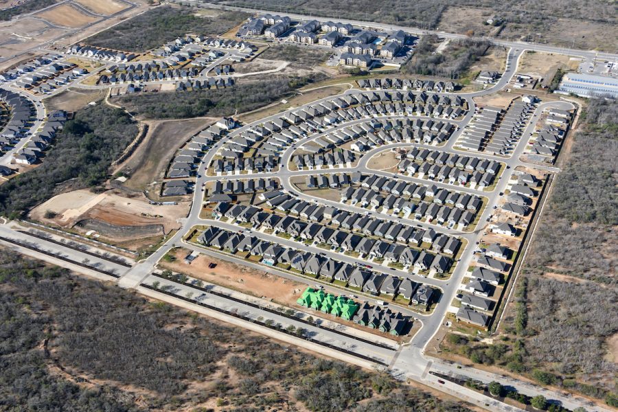 An aerial view of the VIDA San Antonio community in 2025, featuring homes, apartments, townhomes and the Madla Greenway.