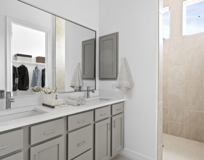 A stand-in shower and a his and her sink in a Sitterle bathroom.